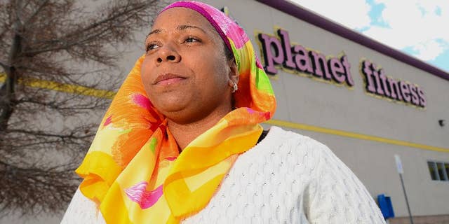 Tarainia McDaniel is photographed in front of Planet Fitness in Albuquerque, N.M., March 2, 2014.  The Albuquerque Planet Fitness refused to let McDaniel a New Mexico Muslim woman,  wear her religious head covering when she tried to work out, according to a new lawsuit. An attorney for McDaniel, 37, recently filed the lawsuit in a New Mexico district court stemming after a 2011 clash that prevented McDaniel from using the gym, even though court documents said another Planet Fitness had previously let her.  (AP Photo/The Albuquerque Journal, Adolphe Pierre-Louis)