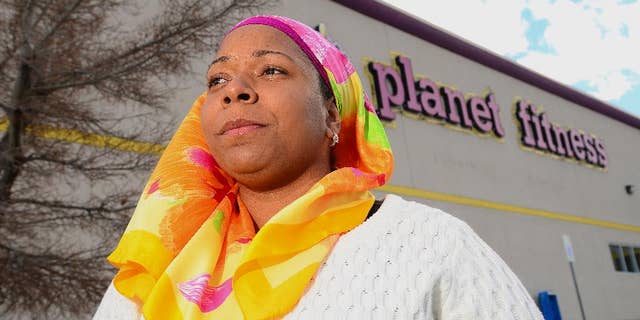 Tarainia McDaniel is photographed in front of Planet Fitness in Albuquerque, N.M., March 2, 2014. The Albuquerque Planet Fitness refused to let McDaniel a New Mexico Muslim woman, wear her religious head covering when she tried to work out, according to a new lawsuit. An attorney for McDaniel, 37, recently filed the lawsuit in a New Mexico district court stemming after a 2011 clash that prevented McDaniel from using the gym, even though court documents said another Planet Fitness had previously let her. (AP Photo/The Albuquerque Journal, Adolphe Pierre-Louis)