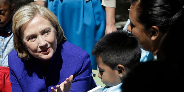 Hillary Clinton talks with families that are participating in the "Talking is Teaching: Talk Read Sing"campaign at the Children's Hospital Oakland Research Institute on July 23, 2014 in Oakland, California. (Photo by AP Photo/Getty Images)