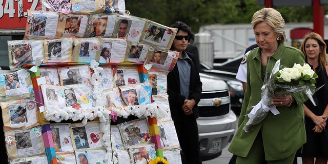 ORLANDO, FL - JULY 22: Democratic presidential candidate former Secretary of State Hillary Clinton visits a memorial outside of the Pulse nightclub where 49 people were shot and killed by a gunman in June on July 22, 2016 in Orlando, Florida. With three days to go until the Democratic National Convention, Hillary Clinton is campaigning in Florida. (Photo by Justin Sullivan/Getty Images)