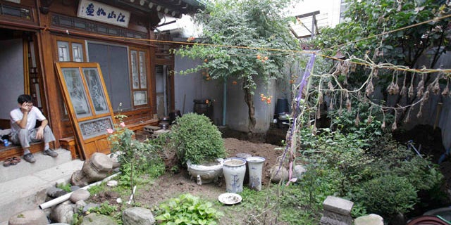 August 21: A South Korean worker takes a rest as he demolishes the Ojinam, Seoul's last restaurant of its kind and one of the city's most famous examples of traditional Korean architecture, in Seoul, South Korea. (AP)