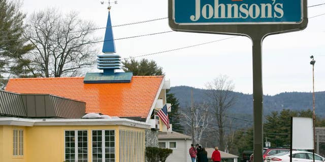 In this Wednesday, April 8, 2015 photo, customers walk into Howard Johnson's Restaurant in Lake George, N.Y. The HoJo’s on the main strip of the Adirondack Mountain resort town of Lake George and another in Bangor, Maine, are the last two restaurants operating under the famous name. (AP Photo/Mike Groll)