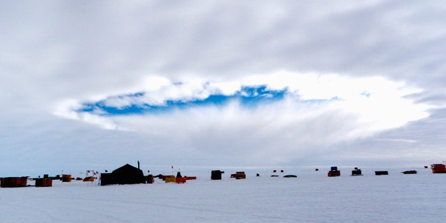 An aircraft-induced hole observed at the West Antarctic Ice Sheet Divide Camp, Antarctica. Airplanes flying through supercooled clouds around airports can cause condensation that results in more snow and rain nearby, according to a new study.