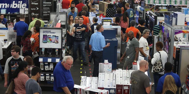 Nov. 26, 2015: People look at merchandise while holiday shopping at Best Buy in Panama City, Fla. (Patti Blake/News Herald via AP)