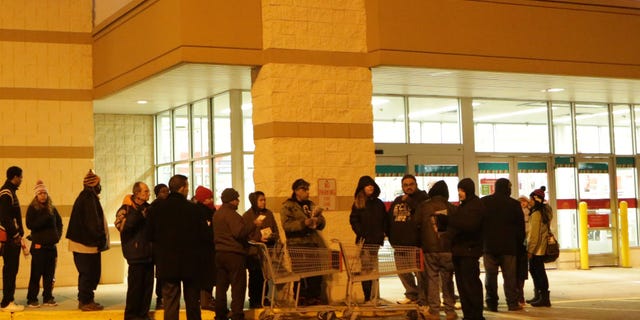 Nov. 27, 2014: Customers line up outside a Kmart store on Thanksgiving morning in Chicago, Ill.