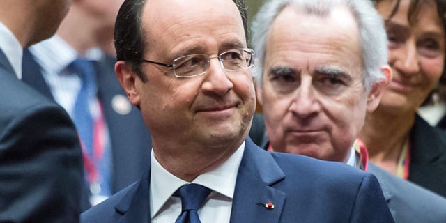 March 6, 2014: French President Francois Hollande, center, speaks with Ukraine's Prime Minister Arseniy Yatsenyuk, left, during a round table meeting at an EU summit in Brussels.