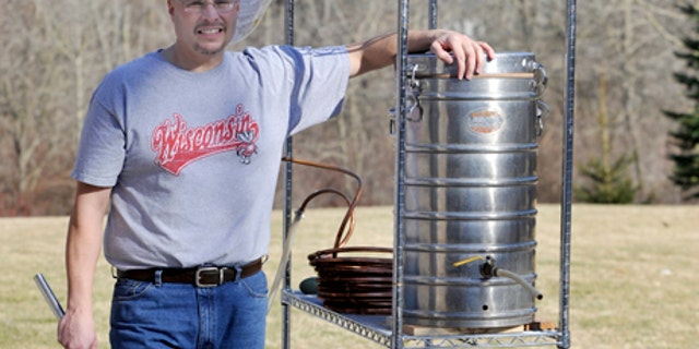 March 10, 2012: Kevin Flynn, 46, of Caledonia, Wis., poses with some of his home brewing equipment. An explosion of interest in home beer brewing is forcing lawmakers across the country to review long-forgotten alcohol laws, some of which date back to Prohibition. (AP Photo/Journal Times, Gregory Shaver)