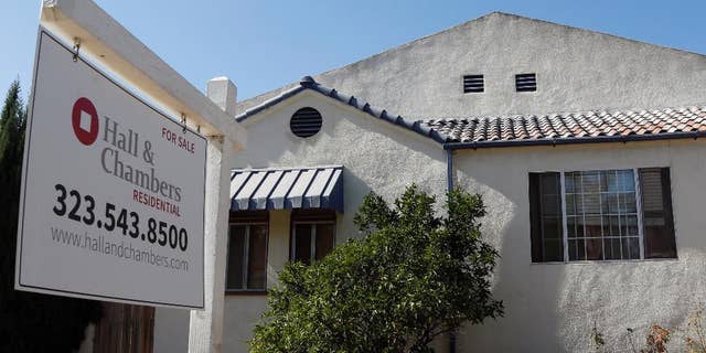 A realty sign hangs outside a home for sale in Los Angeles Monday, Oct 27, 2014. Standard & Poor’s releases its 20-city home price index for August on Tuesday, Oct. 28, 2014. (AP Photo/Nick Ut)