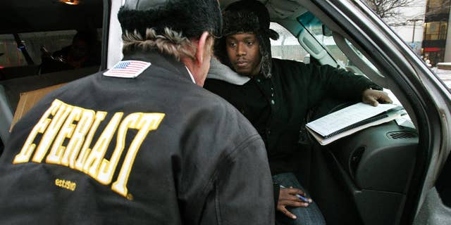 FILE - In this Wednesday, Jan. 28, 2009 file photo, Harold "Hal" Miller, right, listens to a homeless man while preparing census forms for homeless people in Camden, N.J. Miller, well known in Camden for working with the city's homeless population, has been arrested and charged with running a drug market in the city. In an indictment dated Sept. 1, federal authorities say 38-year-old Harold "Hal" Miller ran an operation that sold heroin and crack on Pfeiffer Street in East Camden. (AP Photo/Mel Evans, File)