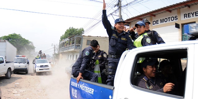 Honduras national policemen arrive at a police district after a work stoppage was declared in Tegucigalpa, Honduras, Tuesday April 23, 2013. About 1800 policemen have started a work stoppage to demand that the government improve working conditions for the police. The work stoppage comes at a time when the national police is being strongly criticized for the poor results fighting crime with statistics that place Honduras as one of the most violent countries in the world, holding a homicide rate of 91 per 100,000 residents. (AP Photo/Fernando Antonio)