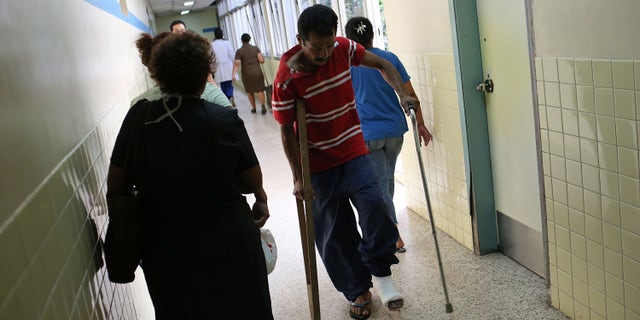 A man limps through the hallways of a public hospital on July 19, 2012 in Tegucigalpa, Honduras.