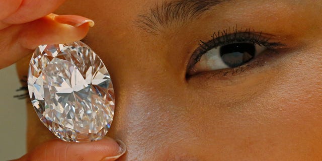 Sept. 19, 2013 - FILE - A 118.28-carat white diamond is at Sotheby's auction house in Hong Kong. The white diamond the size of a small egg has sold for $27.3 million. A phone bidder bought the rock from Africa at the Oct. 7 sale.