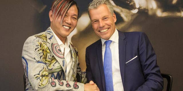In this Tuesday, Sept. 16, 2014 photo provided by Rolls-Royce Motor Cars, Louis XIII Holdings Ltd. Chairman Stephen Hung, left, poses with Rolls-Royce Motor Cars CEO Torsten Mueller-Oetvoes at the Rolls-Royce's headquarters in Goodwood, Britain. Hung, a Hong Kong tycoon, placed the biggest ever order for Rolls-Royce cars, agreeing to buy 30 Phantoms for $20 million for a luxury resort he’s building in the global gambling capital of Macau. Hung and Rolls-Royce executives signed the deal Tuesday at the company’s Goodwood factory. (AP Photo/Rolls-Royce Motor Cars, Mark Bramley)