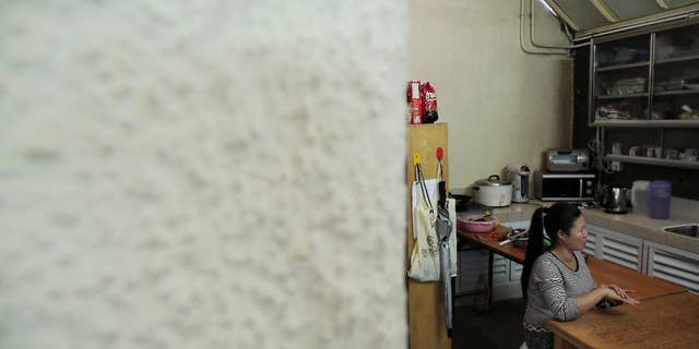A Filipino domestic worker, who asked to be identified only by her first name, Babylen, speaks during an interview with The Associated Press at a shelter opened for unemployed domestic workers in Hong Kong Friday, Nov. 7, 2014. More than 160,000 Indonesians, almost all women, have taken similarly perilous routes to jobs as maids, nannies and housekeepers in Hong Kong, lured by salaries as much as five times higher than at home. Now, they’re mourning two of their own Seneng Mujiasih and Sumarti Ningsih, former domestic workers in their 20s who were found stabbed to death last weekend in the luxury apartment of British investment banker Rurik George Caton Jutting. For Babylen the past year and a half in Hong Kong has been a bitter disappointment. An injury on the job led to her dismissal in March. Now, she’s waiting to receive compensation while sleeping in the shelter. (AP Photo/Vincent Yu)
