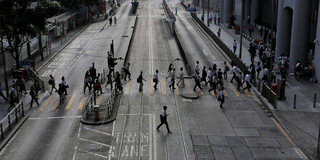 Oct. 9: People walk to work in the occupied areas at Central district in Hong Kong.