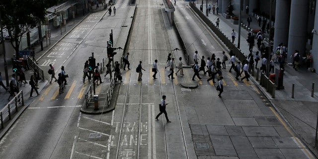 Oct. 9: People walk to work in the occupied areas at Central district in Hong Kong.