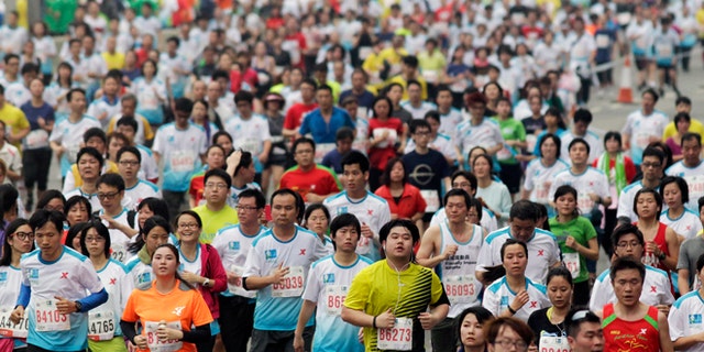 Feb. 24, 2013: Participants run on the Eastern Corridor expressway during a 10-kilometer race as part of the Hong Kong Marathon.