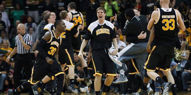 Milwaukee players celebrate after defeating Wright State 69-63 in an NCAA college basketball game for the Horizon League men's tournament championship, Tuesday, March 11, 2014, in Dayton, Ohio. (AP Photo/Dayton Daily News, Ty Grenlees) LOCAL PRINT OUT AND LOCAL TV OUT (WKEF, WRGT, WDTN)