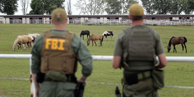 June 12, 2012: FBI agents overlook a horse ranch under investigation in Lexington, Okla. Federal agents raided the Oklahoma ranch and a prominent quarter horse track in New Mexico on Tuesday, alleging the brother of a high-ranking official in a Mexican drug cartel used a horse-breeding operation to launder money.