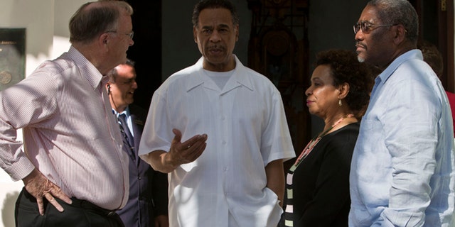 Congressman Emanuel Cleaver, center, speaks to Congressman Sam Farr, left, Congresswoman, Barbara Lee, second from right, and Congressman Gregory Meeks outside the Hotel Saratoga in Havana, Cuba, Monday, May 5, 2014. The congressmen had previously spoken at a press conference about imprisoned U.S. government subcontractor Alan Gross. (AP Photo/Franklin Reyes)