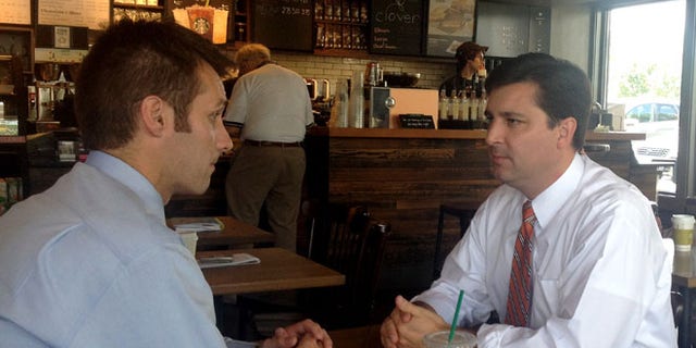 FILE: June 30, 2014: North Carolina Republican House candidate David Rouzer, right, talking with a campaign aide, in Raleigh, N.C.