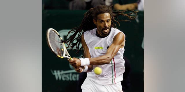 Dustin Brown hits a return against John Isner at the U.S. Men's Clay Court Championship tennis tournament on Wednesday, April 9, 2014, in Houston. (AP Photo/Houston Chronicle, Bob Levey) MANDATORY CREDIT