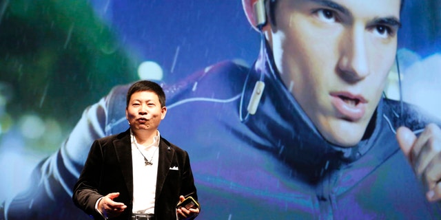 Huawei Chief Executive Richard Yu presents the TalkBand N1 during a news conference in Barcelona March 1, 2015.
