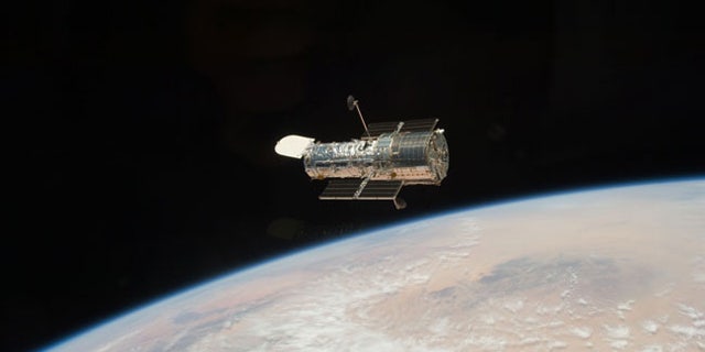 The Hubble Space Telescope, seen here in orbit above the Earth, after it was released from the shuttle Atlantis at the close of the STS-125 servicing mission in May 2009.