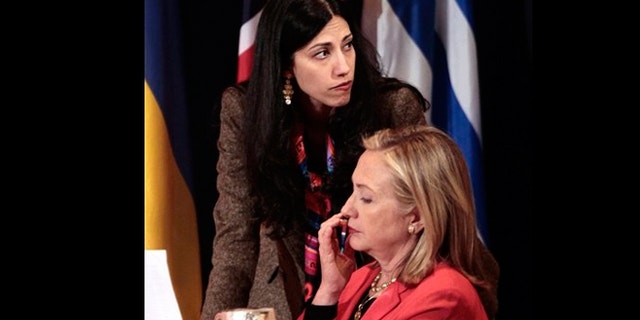 In this Sept. 20, 2011 file photo, Huma Abedin, top, deputy chief of staff and aide to Secretary of State Hillary Rodham Clinton, right, during a meeting with leaders for the Open Government Partnership in New York.