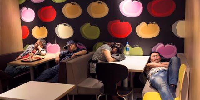 A group of people sleep in a 24-hour McDonald���s in Hong Kong. A new study found humans are more efficient sleepers than our primate ancestors.