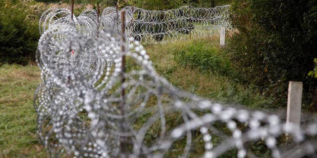 A part of the temporary fence is seen at the green border between Hungary and Croatia at Zakany, 234 kms southwest of Budapest, Hungary, Tuesday, Sept. 29, 2015. (Gyorgy Varga/MTI via AP)