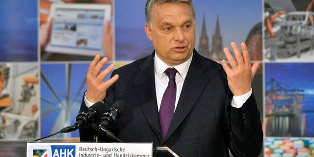 Hungarian Prime Minister Viktor Orban addresses the annual meeting of the German-Hungarian Chamber of Commerce and Industry in the Budapest Business School in Budapest, Hungary, Thursday, May 7, 2015. ( Zoltan Mathe/MTI via AP)