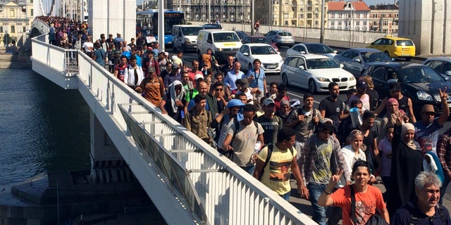 Sept, 4, 2015 - Hundreds of migrants cross the river Danube in Budapest, after deciding to walk toward Austria. Thousands have been camped out at Budapest's Keleti train station for days, before they decided to try to reach their destination on foot.