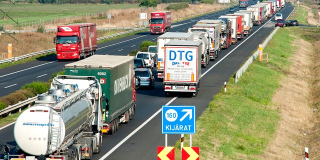 Aug. 31, 2015: A long queue of vehicles waits on the M1 motorway near the border between Hungary and Austria near Mosonmagyarovar, 158 km northwest from Budapest, Hungary. (Csaba Krizsan/MTI via AP)