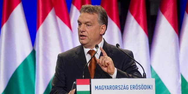 FILE - In this Feb. 27, 2015 file photo Hungarian Prime Minister Viktor Orban delivers his annual "state of the nation" speech in Budapest, Hungary. A debate about restoring the death penalty has been a recurring issue with Orban since a 2002 bank robbery in which eight people were murdered. The inscription reads: "Hungary Grows Stronger". (Szilard Koszticsak/MTI via AP, File)