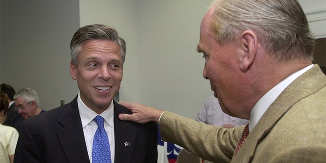 Jon Huntsman, Jr., learns from his father, Jon Huntsman, Sr. that his son was declared the winner by The Associated Press during the Republican primary election Tuesday, June 22, 2004, in Salt Lake City. Huntsman opposed Nolan Karras to be the GOP's gubernatorial candidate. (AP Photo/Douglas C. Pizac)