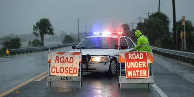 Police block the road entering Cedar Key, Fla., as Hurricane Hermine nears the Florida coast, Thursday, Sept. 1, 2016.