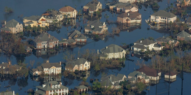 Neighborhoods are flooded with oil and water two weeks after Hurricane Katrina went through New Orleans, Sept. 12, 2005.