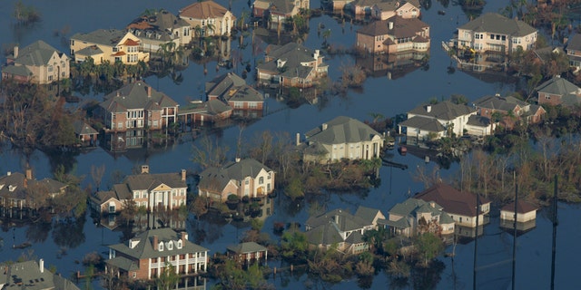 Neighborhoods are flooded with oil and water two weeks after Hurricane Katrina went through New Orleans, Sept. 12, 2005.