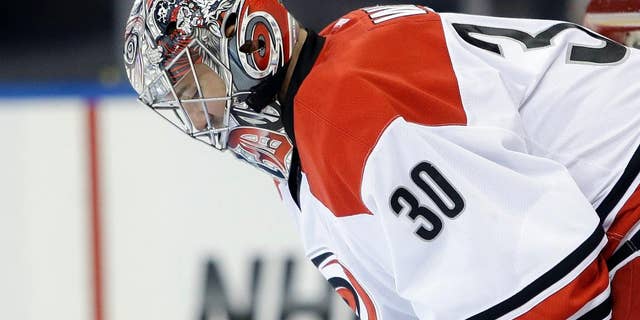 Carolina Hurricanes goalie Cam Ward looks down after New York Rangers' Benoit Pouliot scored during the second period of an NHL hockey game Tuesday, April 8, 2014, in New York. (AP Photo/Frank Franklin II)