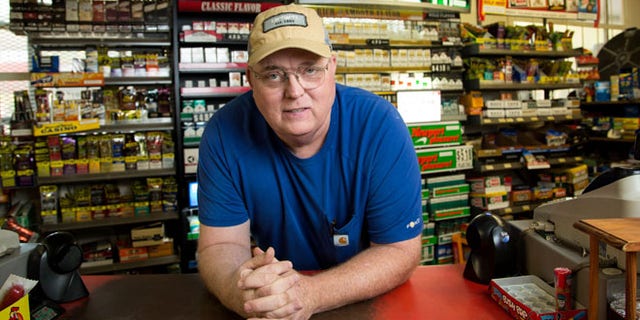Businessman Lyndon McLellan stands in front of his store L&M Convenience Mart in Fairmont, N.C.