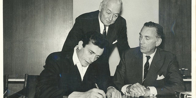 Johnny Cash, producer Don Law and Columbia Records president Goddard Lieberson, 1961.
