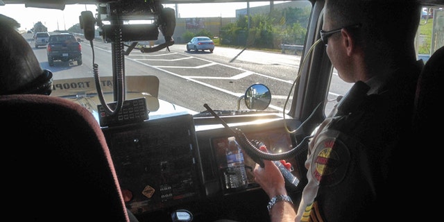 State troopers hide in plain sight to recapture the attention of distracted drivers.