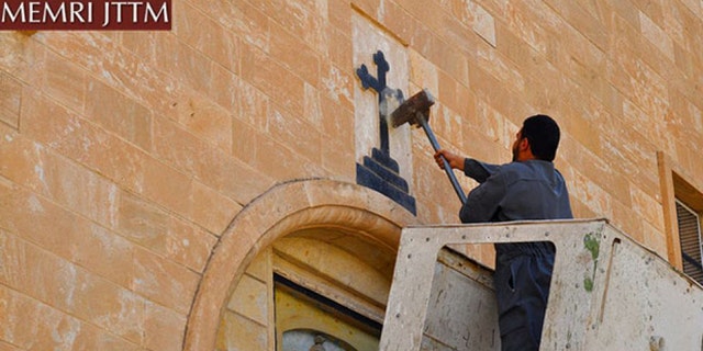 ISIS men destroy various Christian symbols in Nineveh, Iraq.