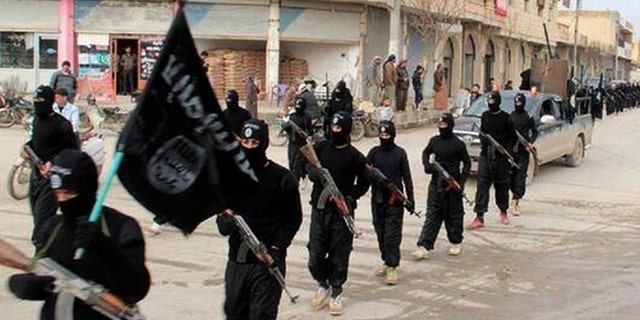 Jan. 14, 2014: Fighters from ISIS marching in Raqqa, Syria.