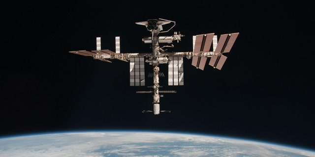 The International Space Station and the docked space shuttle Endeavour, flying at an altitude of approximately 220 miles, seen from the Soyuz TMA-20 following its undocking on May 23, 2011 (USA time). It is the first-ever image of a space shuttle docked to the International Space Station.