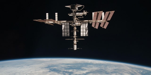 The International Space Station and the docked space shuttle Endeavour, flying at an altitude of approximately 220 miles, seen from the Soyuz TMA-20 following its undocking on May 23, 2011 (USA time). It is the first-ever image of a space shuttle docked to the International Space Station.
