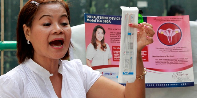 A medical worker explains a family planning method using the intrauterine device (IUD).