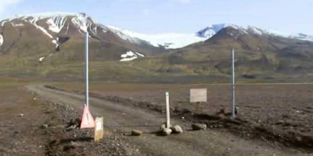 In an image from an Aug. 19, 2014 video, a sign is posted on the road next to Bardarbunga, a subglacial stratovolcano located under Iceland's largest glacier. (AP/Courtesy Channel 2 Iceland)