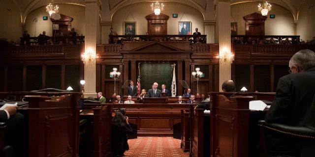 FILE - In this Jan. 25, 2017 file photo, Illinois Gov. Bruce Rauner delivers speaks in the Illinois House chamber in Springfield, Ill. Illinois is on track to become the first U.S. state to have its credit rating downgraded to "junk" status, a move that will deepen a multibillion-dollar financial hole and cost taxpayers more for years to come. (Ted Schurter/The State Journal-Register via AP File)